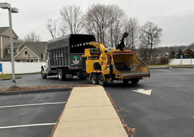 A truck driving away after an after-hours storm damage cleanup in Bristol, CT