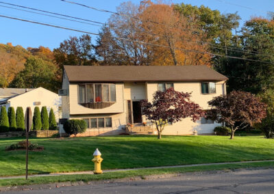 A house with trees in front in Southington, CT